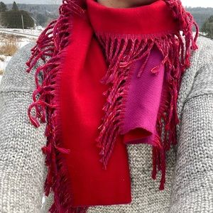 Reversible red/pink tasseled knit scarf.
